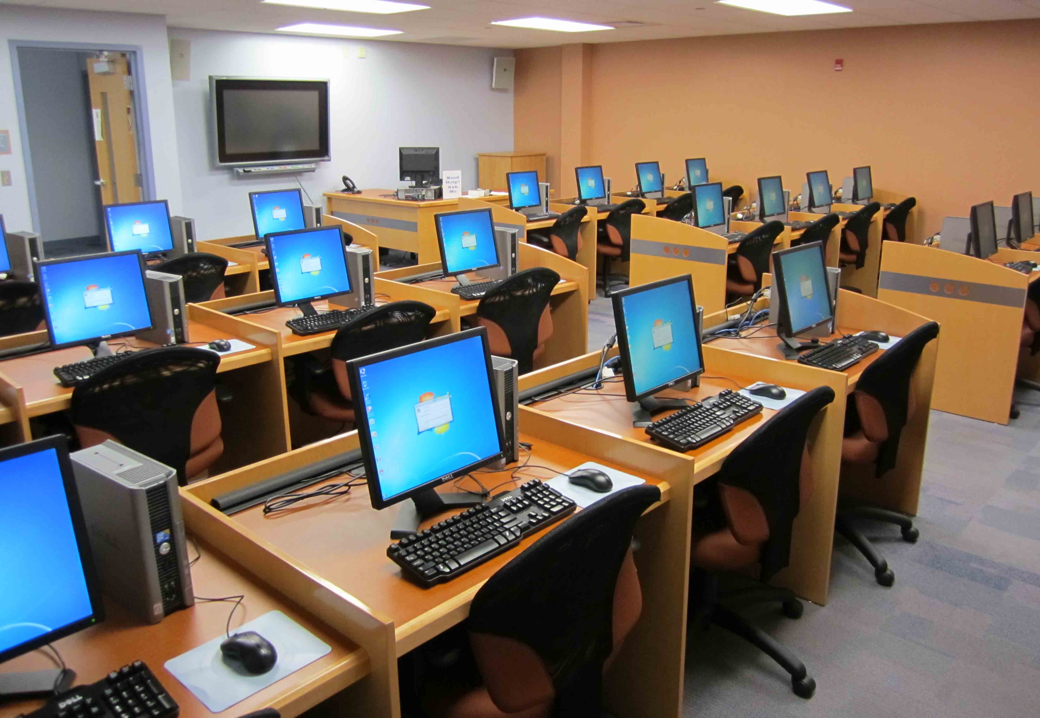 Photo: the computer lab, machines on, students at them